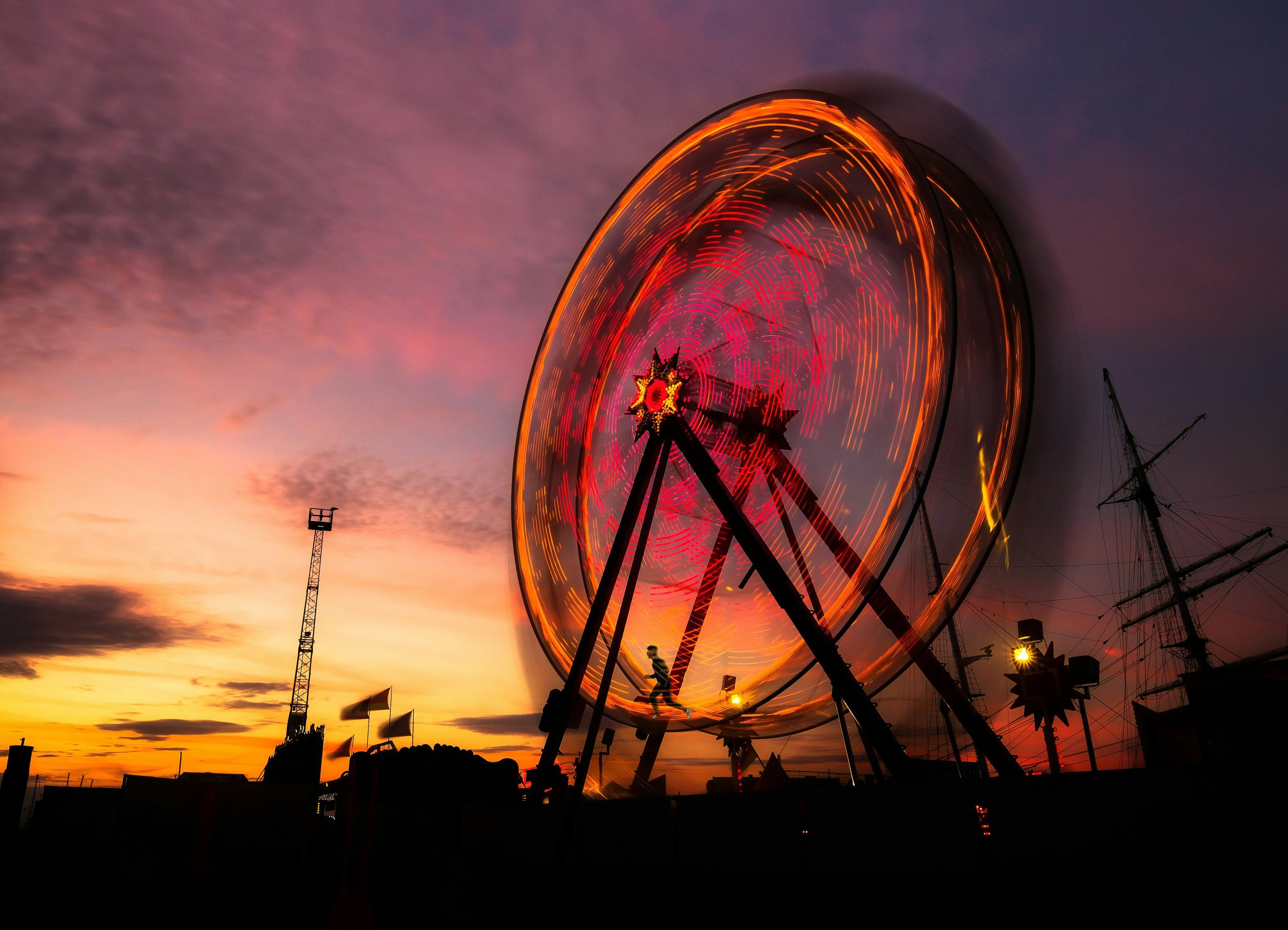 A person is running on a very large ferris wheel. This represents the never ending struggle one finds themselves in when taking medications to resolve symptoms.